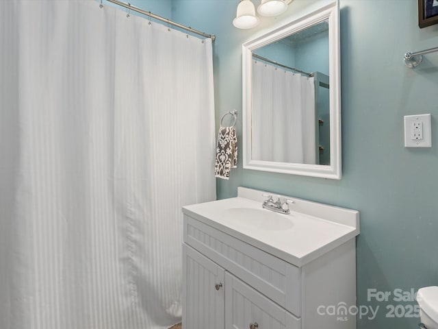 bathroom featuring toilet and vanity