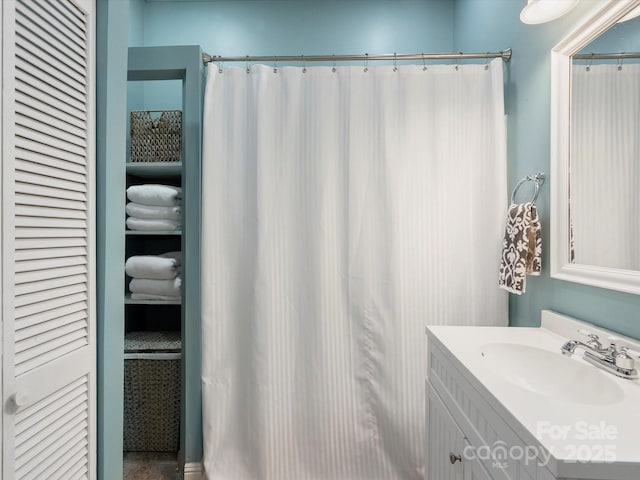 full bath featuring a closet and vanity