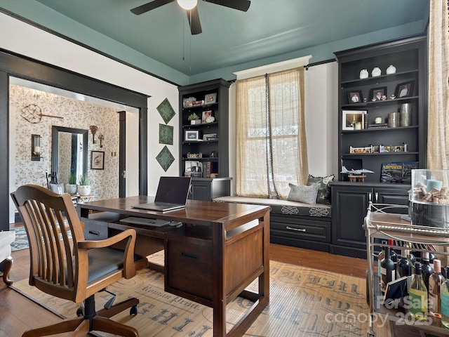 office space with light wood-type flooring, wallpapered walls, and ceiling fan