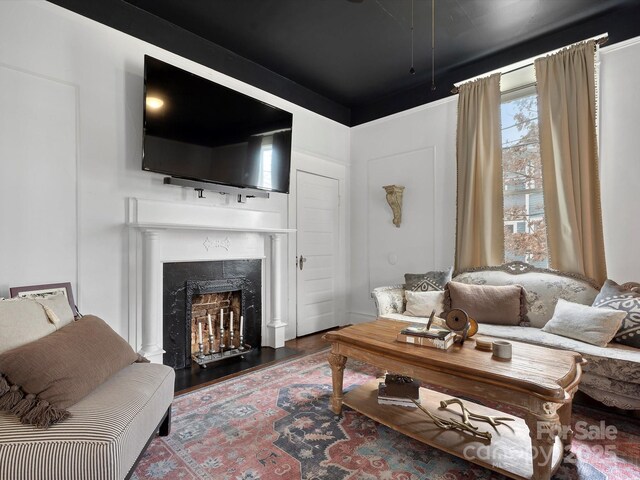 living room with a fireplace and wood finished floors