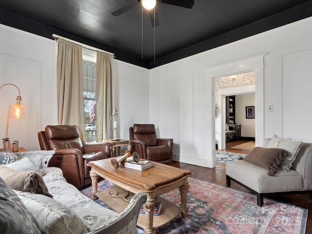 living area featuring a ceiling fan and wood finished floors