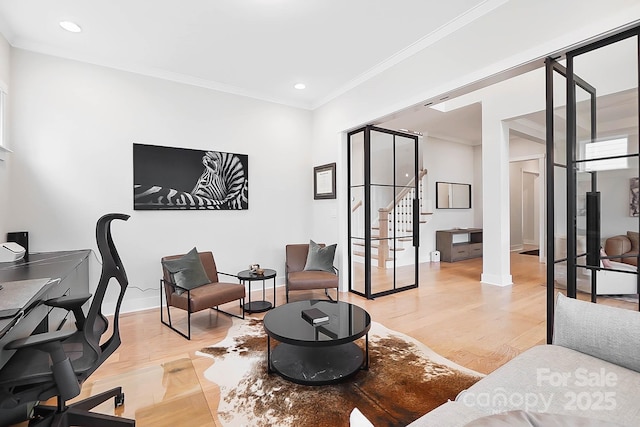 office space with ornamental molding and light wood-type flooring