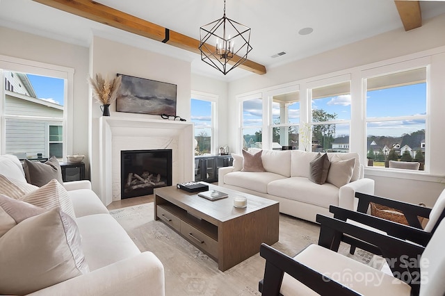 living room with a notable chandelier and beam ceiling