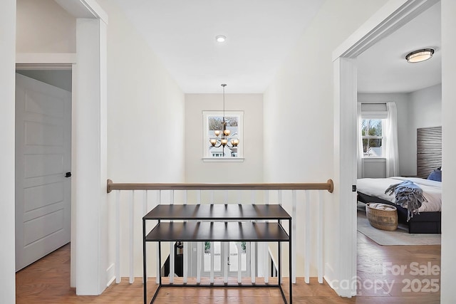 interior space with hardwood / wood-style flooring and an inviting chandelier