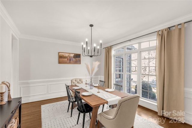 dining room with hardwood / wood-style flooring, ornamental molding, and plenty of natural light