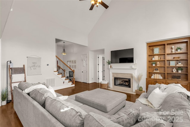 living room featuring high vaulted ceiling, dark wood-type flooring, and ceiling fan