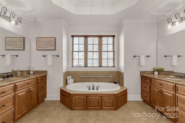 bathroom with crown molding, tile patterned floors, a bathtub, and vanity