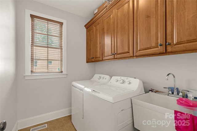 laundry area featuring cabinets, sink, light tile patterned floors, and independent washer and dryer