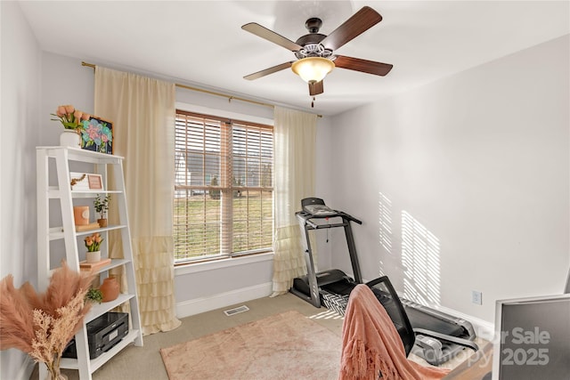 exercise area with light carpet and ceiling fan