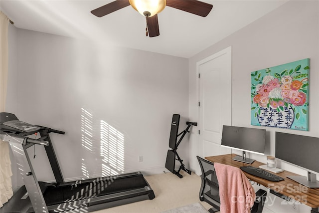 carpeted office featuring ceiling fan