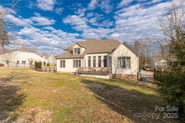 rear view of property with a wooden deck and a yard