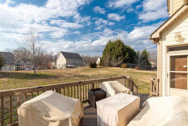 wooden deck featuring a grill and a yard