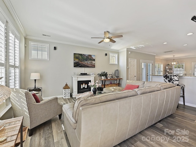 living room featuring ornamental molding, hardwood / wood-style floors, and ceiling fan