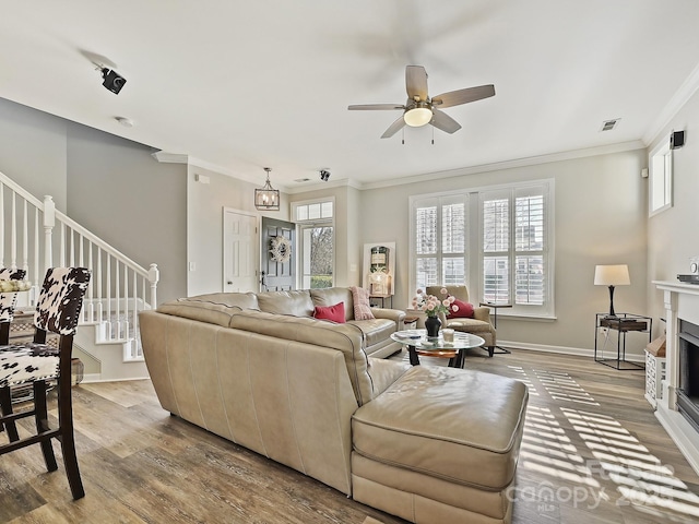 living room featuring ornamental molding, a healthy amount of sunlight, and light hardwood / wood-style floors