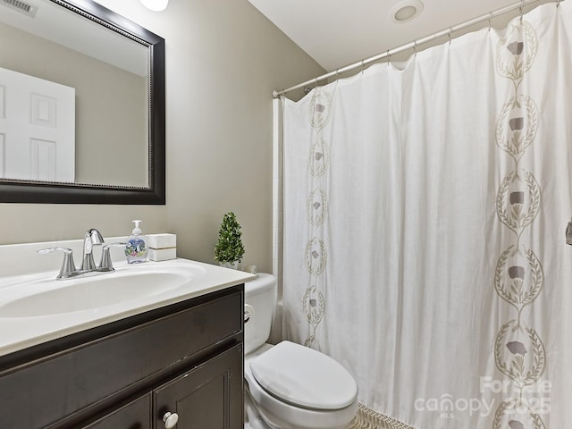 bathroom with vanity, walk in shower, and toilet