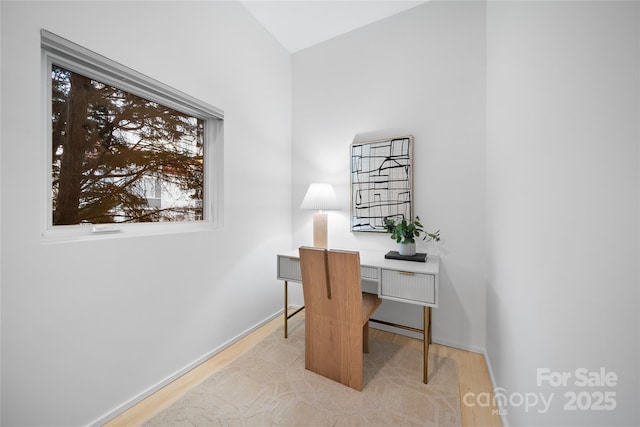 home office with light hardwood / wood-style floors