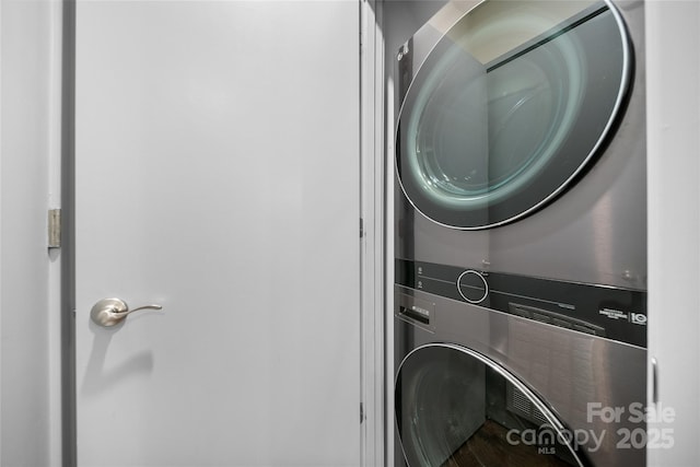 laundry room with stacked washing maching and dryer