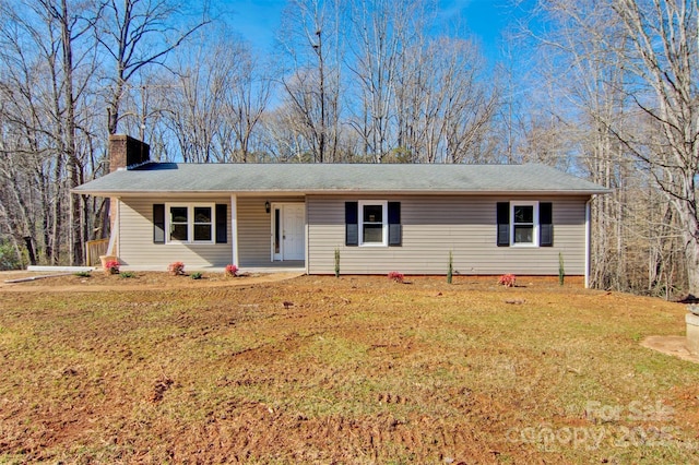 single story home with covered porch and a front yard