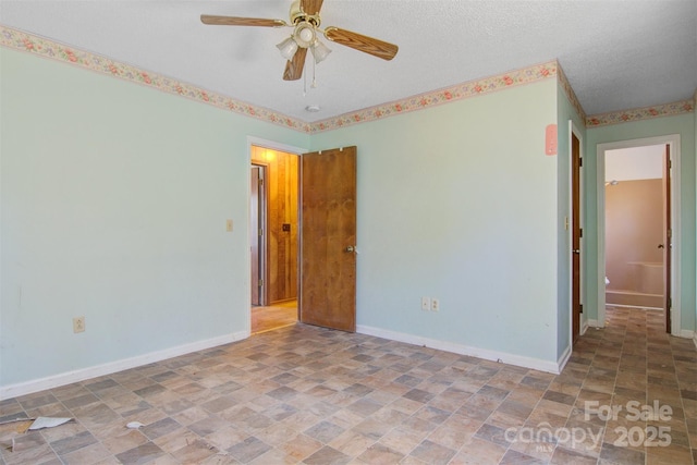 unfurnished room featuring a textured ceiling and ceiling fan