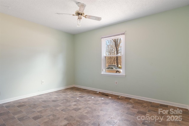 spare room featuring a textured ceiling and ceiling fan