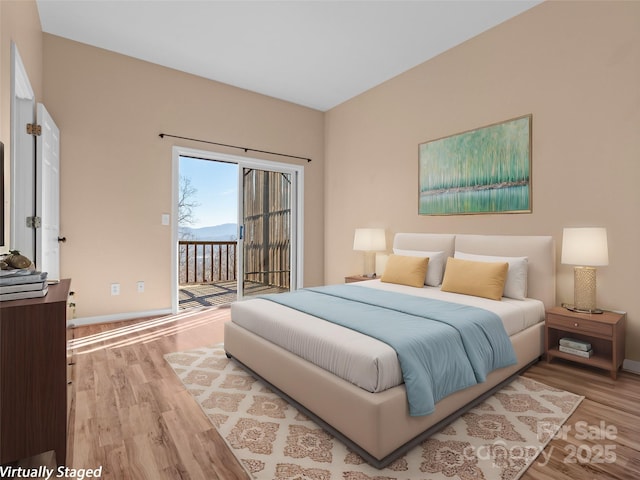 bedroom featuring access to outside and light wood-type flooring