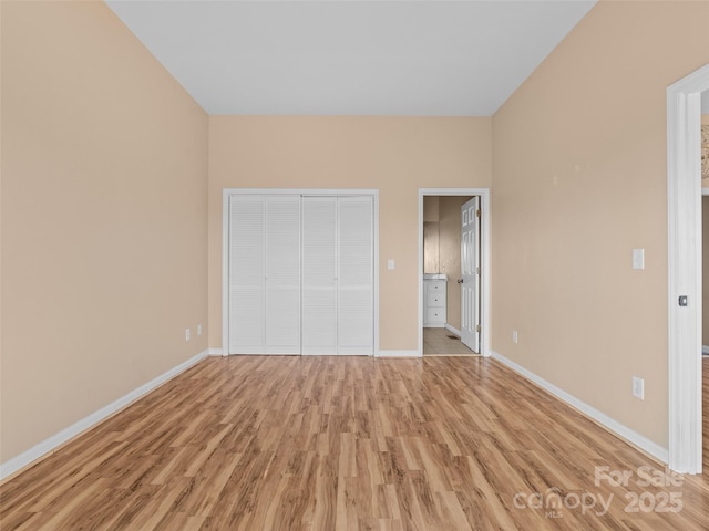 unfurnished bedroom featuring light hardwood / wood-style floors and a closet