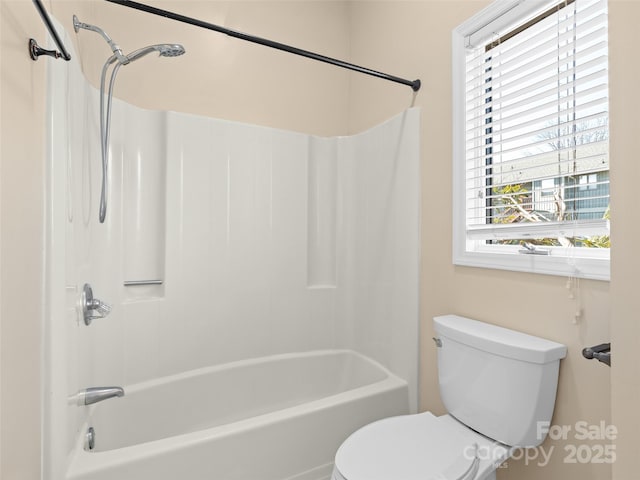 bathroom with shower / washtub combination and toilet