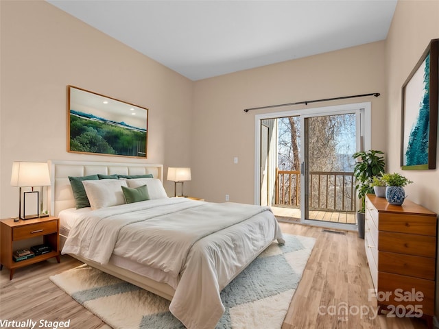 bedroom featuring access to outside and light wood-type flooring