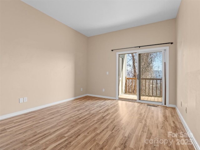 spare room featuring light hardwood / wood-style flooring