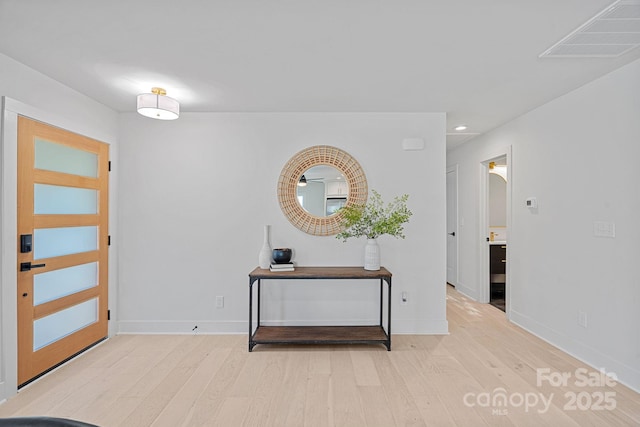 entryway with light hardwood / wood-style floors