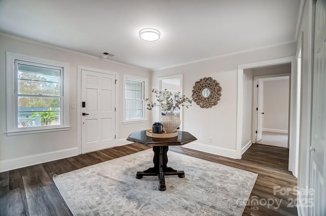 entryway featuring crown molding and dark hardwood / wood-style floors