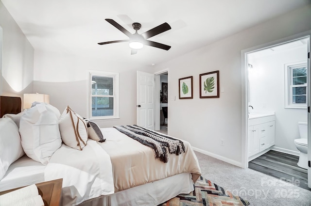 carpeted bedroom with ceiling fan and ensuite bathroom