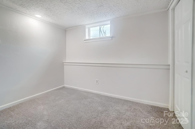 carpeted spare room with a textured ceiling