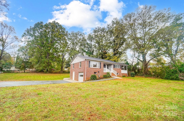 bi-level home featuring a garage and a front yard