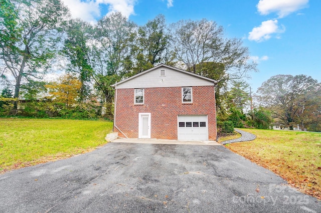 view of side of home featuring a garage and a yard