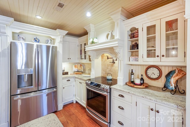 kitchen with white cabinetry, wood ceiling, stainless steel appliances, and light stone counters