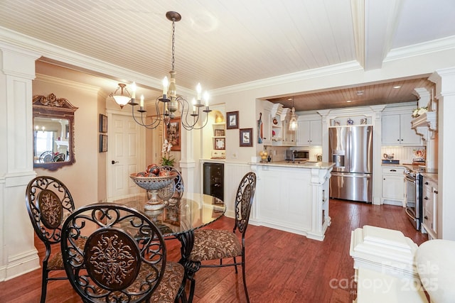 dining area featuring decorative columns, ornamental molding, beverage cooler, and dark hardwood / wood-style flooring