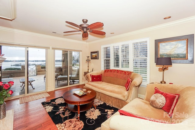 living room featuring ornamental molding, hardwood / wood-style floors, and ceiling fan