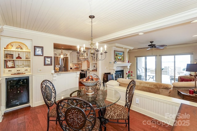 dining area featuring wine cooler, crown molding, dark wood-type flooring, and built in shelves