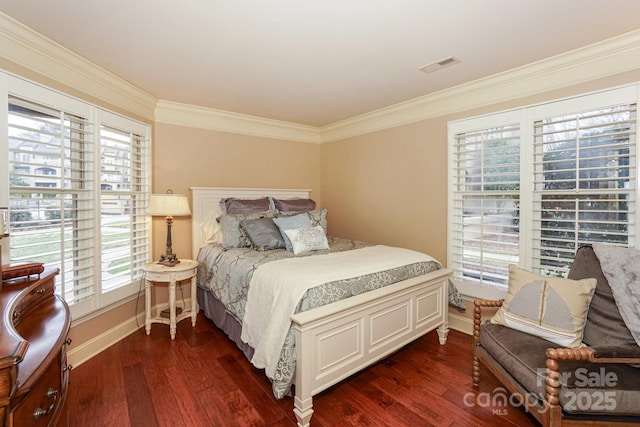 bedroom with ornamental molding and dark hardwood / wood-style flooring