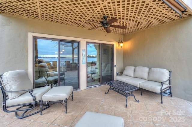 view of patio with an outdoor living space and ceiling fan