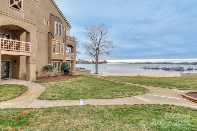 surrounding community featuring a yard and a water view