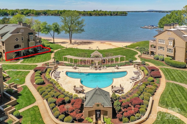 view of swimming pool featuring a water view