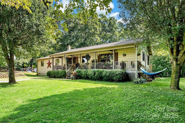 single story home with a chimney, covered porch, a front yard, crawl space, and ceiling fan