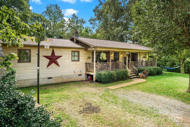 ranch-style home featuring a shingled roof, a chimney, crawl space, a front lawn, and a porch
