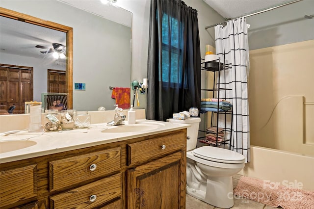 bathroom featuring double vanity, a ceiling fan, toilet, tile patterned floors, and a sink