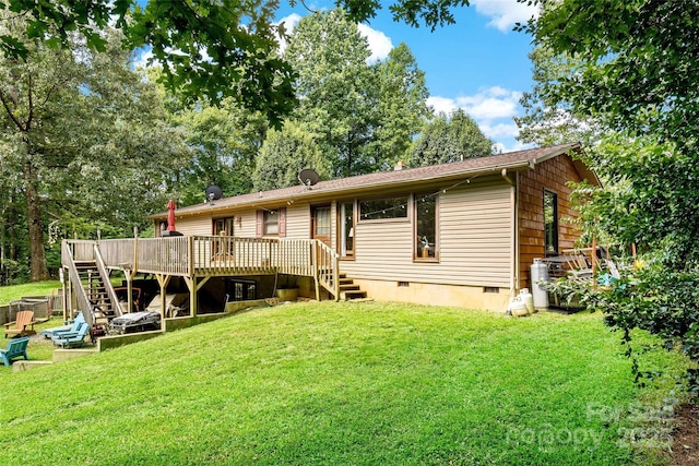back of house with a yard, stairway, crawl space, and a wooden deck