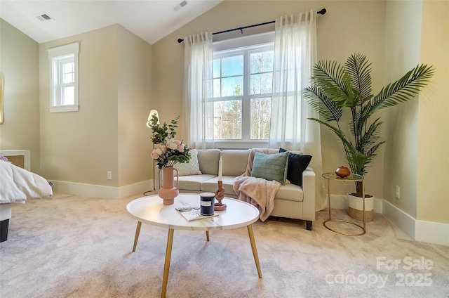 living area with vaulted ceiling and light colored carpet