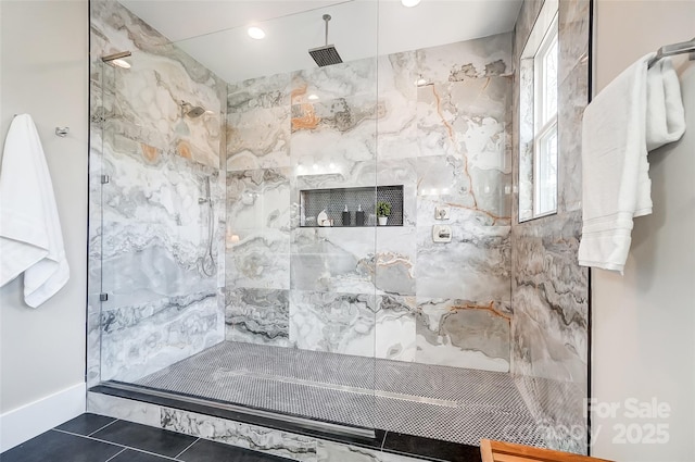 bathroom featuring tiled shower and tile patterned floors