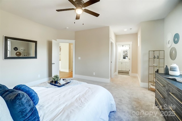 carpeted bedroom with ensuite bathroom and ceiling fan